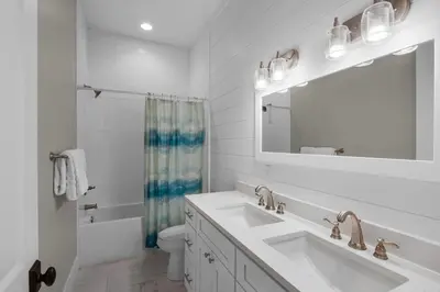 a white bathroom with a sink and a mirror at Lifestyles & Dreams in Santa Rosa Beach