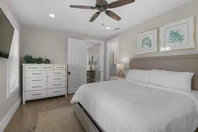 a bedroom with a white bed and a ceiling fan at Lifestyles & Dreams in Santa Rosa Beach