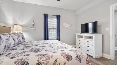 a bedroom with a bed and a flat screen tv at Deep Blue at Laketown Wharf #214 by Nautical Properties in Panama City Beach