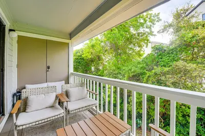 a porch with two chairs and a table at Santa Rosa Beach Townhome Patio, Walk to Beach! in Santa Rosa Beach
