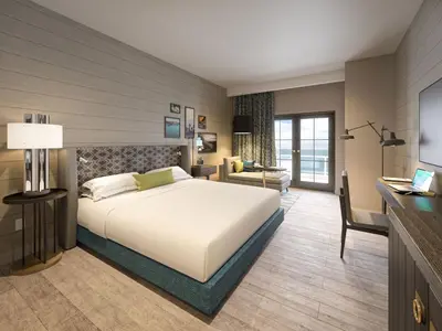 a bedroom with a large white bed and a desk at Hotel Indigo - Panama City Marina by IHG in Panama City