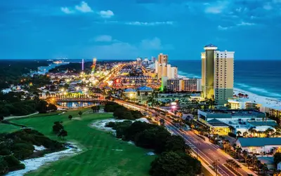 a city at night with the ocean and buildings at Hotel Indigo - Panama City Marina by IHG in Panama City