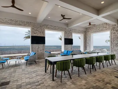 a dining room with a table and chairs and windows at Hotel Indigo - Panama City Marina by IHG in Panama City