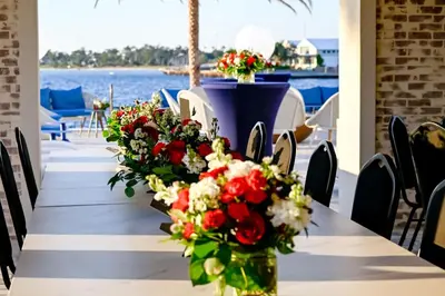 a long table with red and white flowers on it at Hotel Indigo - Panama City Marina by IHG in Panama City