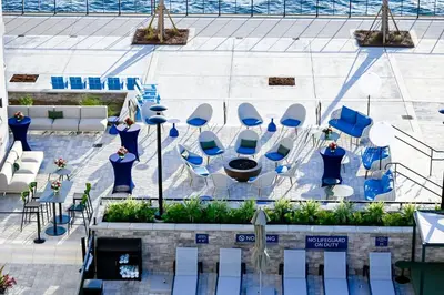 an overhead view of a patio with blue chairs and tables at Hotel Indigo - Panama City Marina by IHG in Panama City
