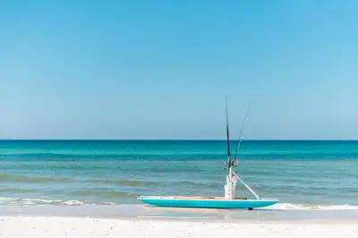 a small blue boat sitting on the beach at One Seagrove Place #1308 - 