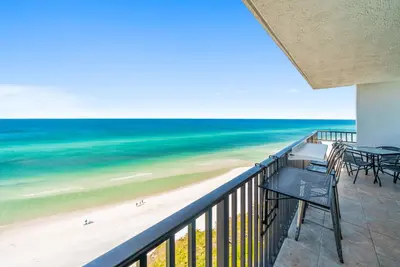 a balcony with a view of the beach and the ocean at One Seagrove Place #1308 - 