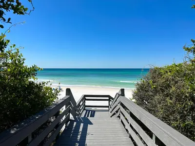 a wooden boardwalk to the beach with the ocean at One Seagrove Place #1308 - 