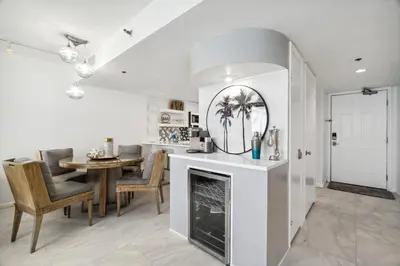 a kitchen and dining room with a fireplace and a table at One Seagrove Place #1308 - 