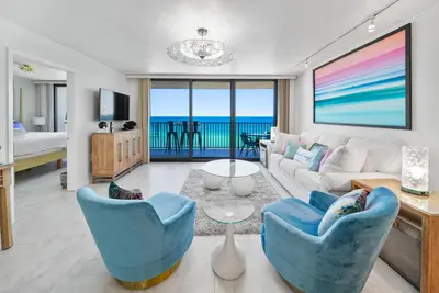 a living room with a view of the ocean at One Seagrove Place #1308 - 