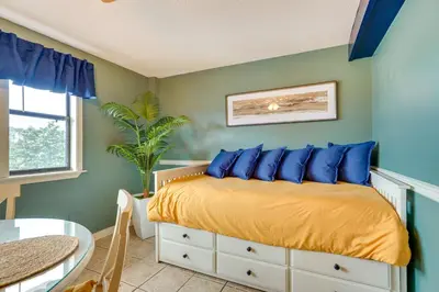 a bedroom with a bed with blue pillows at Charming Panama City Studio with Community Pool! in Panama City Beach