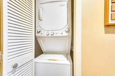 a white washer and dryer in a small room at Charming Panama City Studio with Community Pool! in Panama City Beach