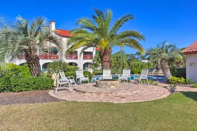a patio with chairs and a fire pit in front of a house at Charming Panama City Studio with Community Pool! in Panama City Beach
