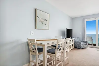 a dining room with a table and chairs at A Shore Thing at Laketown Wharf #1904 by Nautical Properties in Panama City Beach