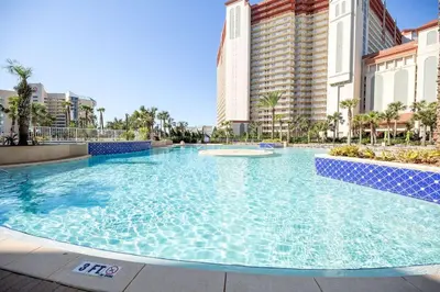 a large swimming pool in front of some buildings at A Shore Thing at Laketown Wharf #1904 by Nautical Properties in Panama City Beach
