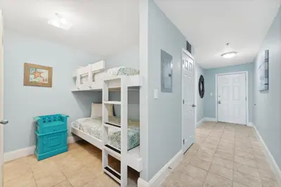 a room with two bunk beds and a hallway at A Shore Thing at Laketown Wharf #1904 by Nautical Properties in Panama City Beach