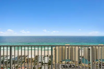 a view of the beach and the ocean from a balcony at A Shore Thing at Laketown Wharf #1904 by Nautical Properties in Panama City Beach
