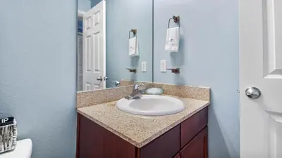 a bathroom with a sink and a mirror at Shell Yeah at Laketown Wharf #730 by Nautical Properties in Panama City Beach