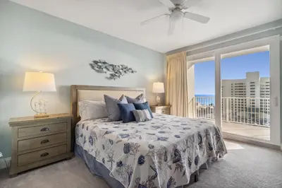 a bedroom with a bed with a view of the ocean at Keep It Beachy at Laketown Wharf #611 by Nautical Properties Vacation Rentals in Panama City Beach