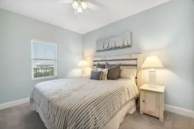 a bedroom with a large bed and a window at Keep It Beachy at Laketown Wharf #611 by Nautical Properties Vacation Rentals in Panama City Beach