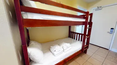two bunk beds in a room with white pillows at Tidewater 2204 in Panama City Beach
