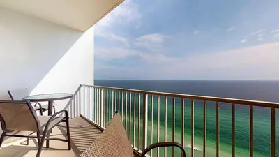a balcony with a table and chairs and the ocean at Tidewater 2613 in Panama City Beach
