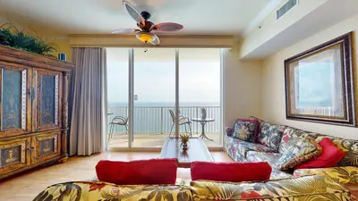 a living room with a couch and a ceiling fan at Tidewater 2613 in Panama City Beach
