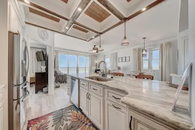 a kitchen with a sink and a counter top at Celadon 209 in Panama City Beach