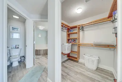 a bathroom with a bed and a toilet in a room at Celadon 209 in Panama City Beach