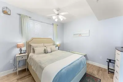 a bedroom with a bed and a ceiling fan at Celadon 209 in Panama City Beach