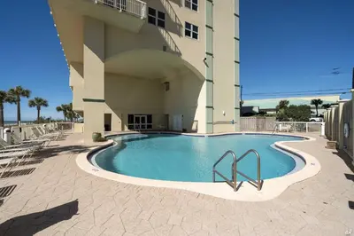 a swimming pool in front of a building at Celadon 209 in Panama City Beach