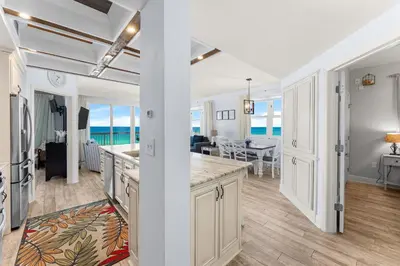 a kitchen and living room with a view of the ocean at Celadon 209 in Panama City Beach