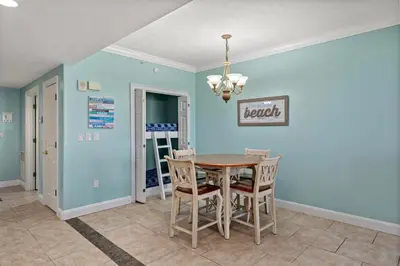 a dining room with a table and chairs at Treasure Island #0105 in Panama City Beach