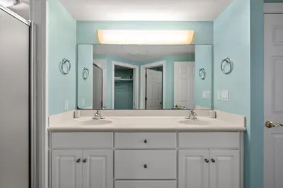 a bathroom with two sinks and a large mirror at Treasure Island #0105 in Panama City Beach
