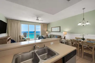 a kitchen and living room with a view of the ocean at Seychelles #1007 in Panama City Beach