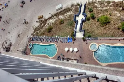 an aerial view of two swimming pools next to a beach at Seychelles #1007 in Panama City Beach