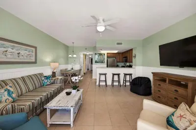 a living room with a couch and a table at Seychelles #1007 in Panama City Beach