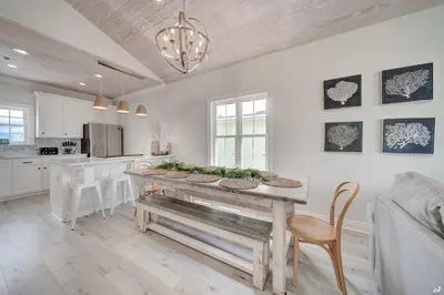a kitchen with a wooden table and a dining room at Summer Towne Cottages #16 in Panama City Beach