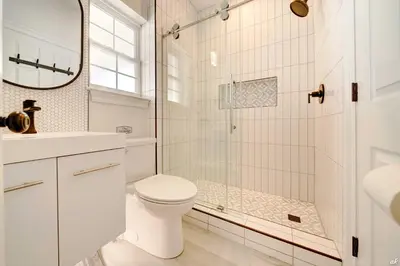 a white bathroom with a shower and a toilet at Summer Towne Cottages #16 in Panama City Beach