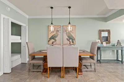a dining room with a table and chairs at Treasure Island #0907 in Panama City Beach