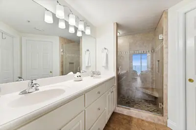 a white bathroom with a sink and a shower at Treasure Island #2110 in Panama City Beach