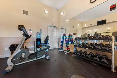 a gym with treadmills and cardio equipment in a room at Treasure Island #2110 in Panama City Beach