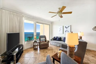 a living room with a couch and a tv at Treasure Island #2110 in Panama City Beach