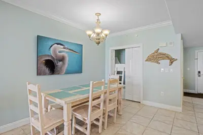 a dining room with a table and chairs at Treasure Island #0206 in Panama City Beach