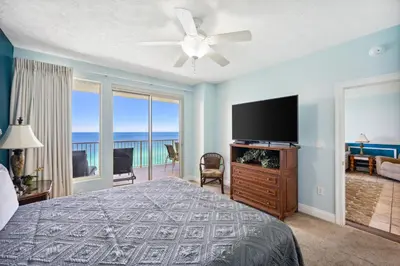 a bedroom with a bed and a flat screen tv at Treasure Island #1608 in Panama City Beach