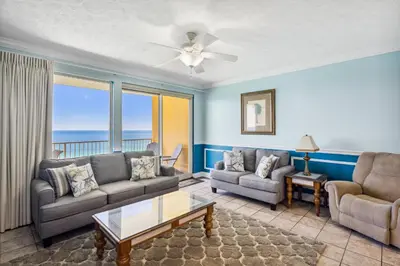 a living room with a couch and a table at Treasure Island #1608 in Panama City Beach