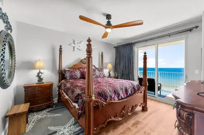 a bedroom with a bed with a view of the ocean at Treasure Island #1110 in Panama City Beach
