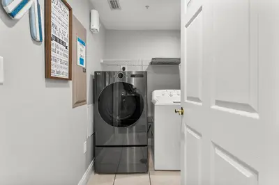 a small kitchen with a washer and dryer at Treasure Island #1110 in Panama City Beach