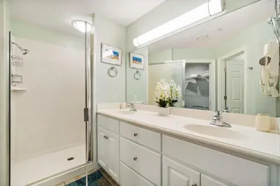 a bathroom with two sinks and a shower at Treasure Island #0303 in Panama City Beach
