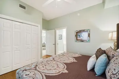 a bedroom with a bed and a large white door at Treasure Island #0303 in Panama City Beach